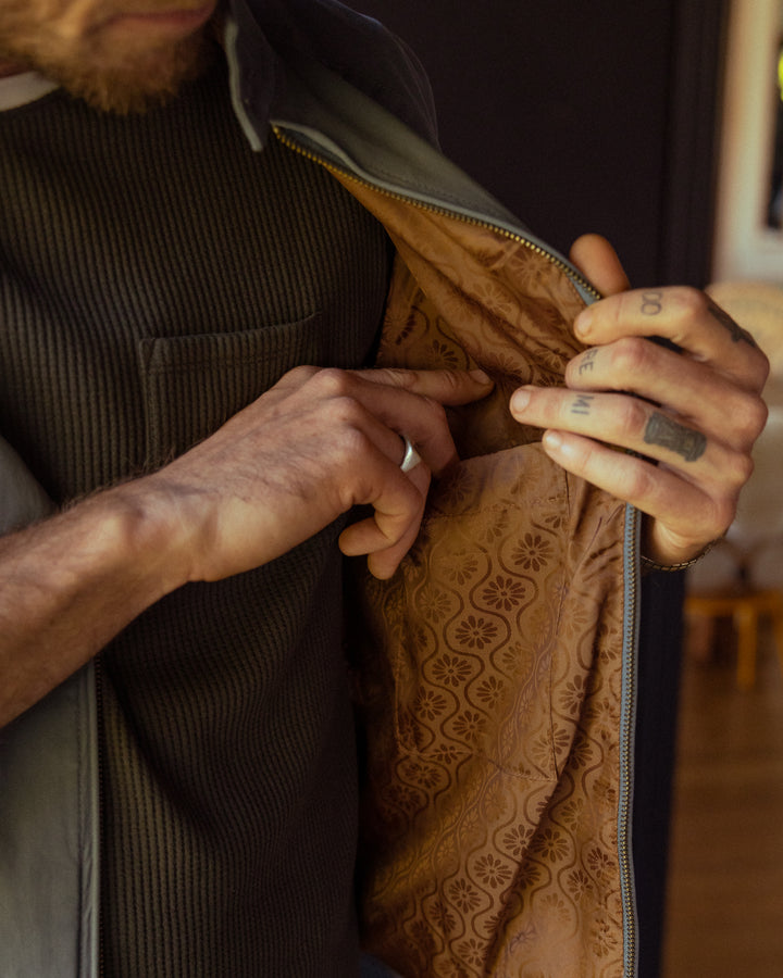 Man opening his jacket to reveal the lightweight shell lining inside The Rhodes Jacket - Abyss by Dandy Del Mar.