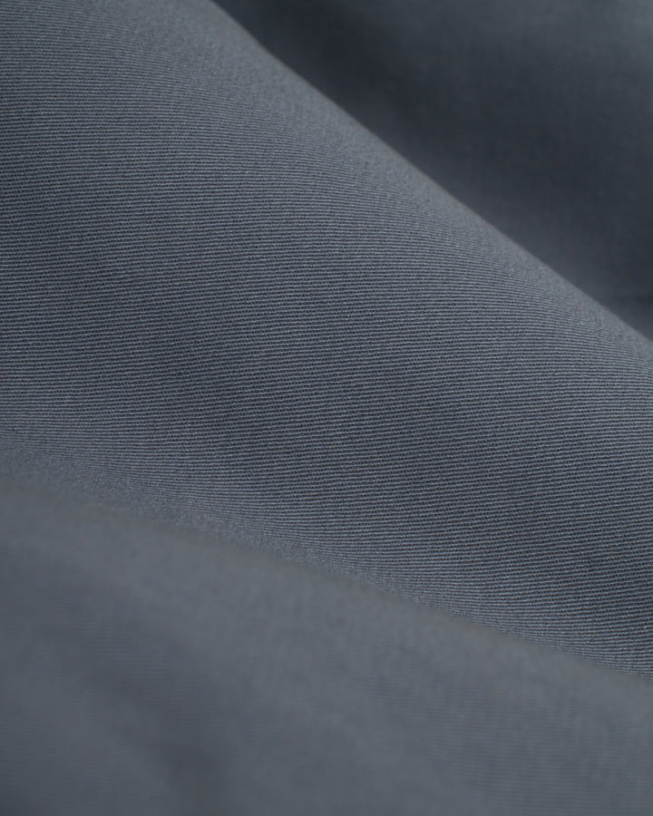 A close up image of a grey washed cotton twill fabric, often used for Dandy Del Mar's Rhodes Jacket - Abyss or deck jackets.