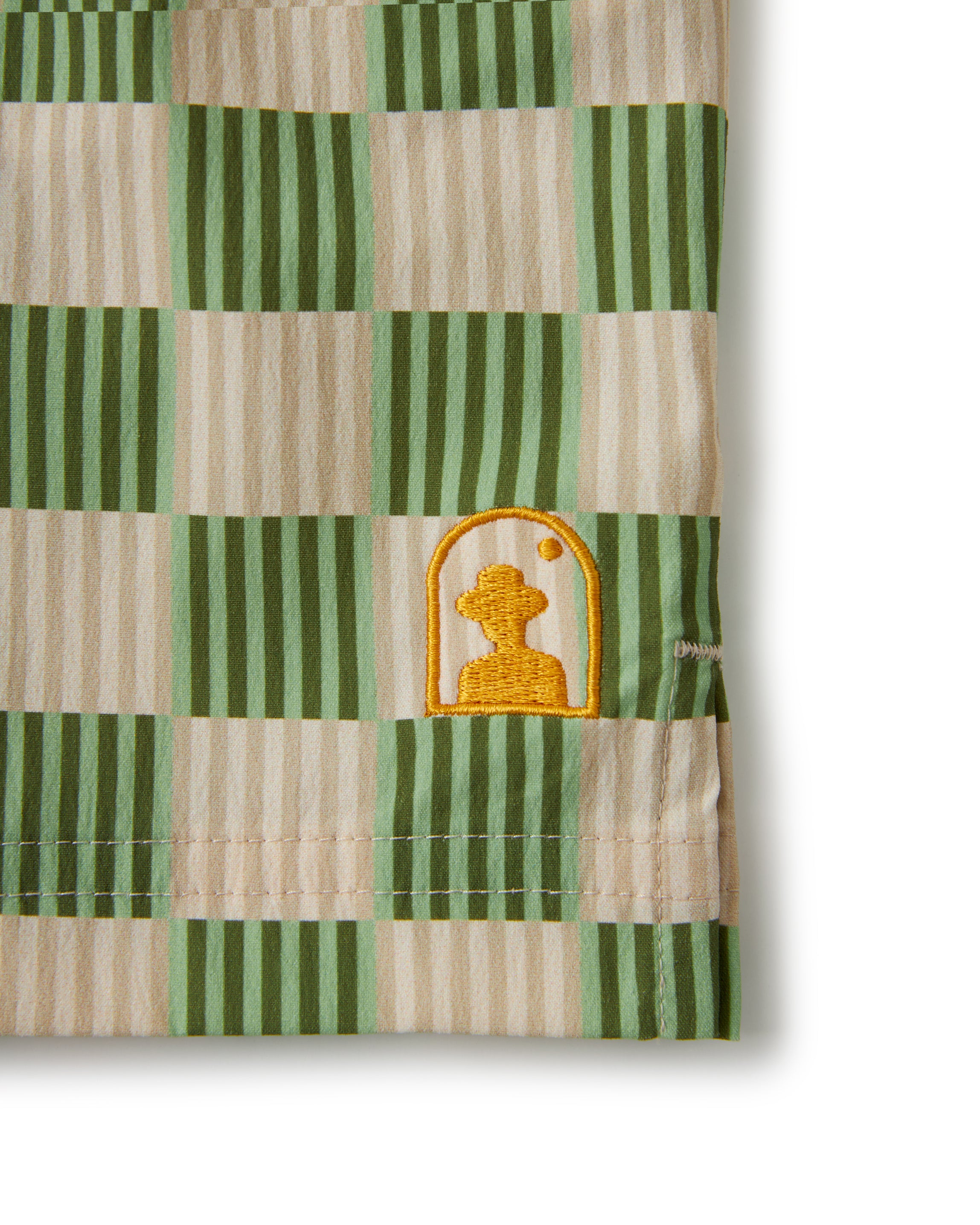 A green and white checkered towel with a teddy bear on it would be replaced by:
The Ventura Volley Short - Arbequina by Dandy Del Mar.