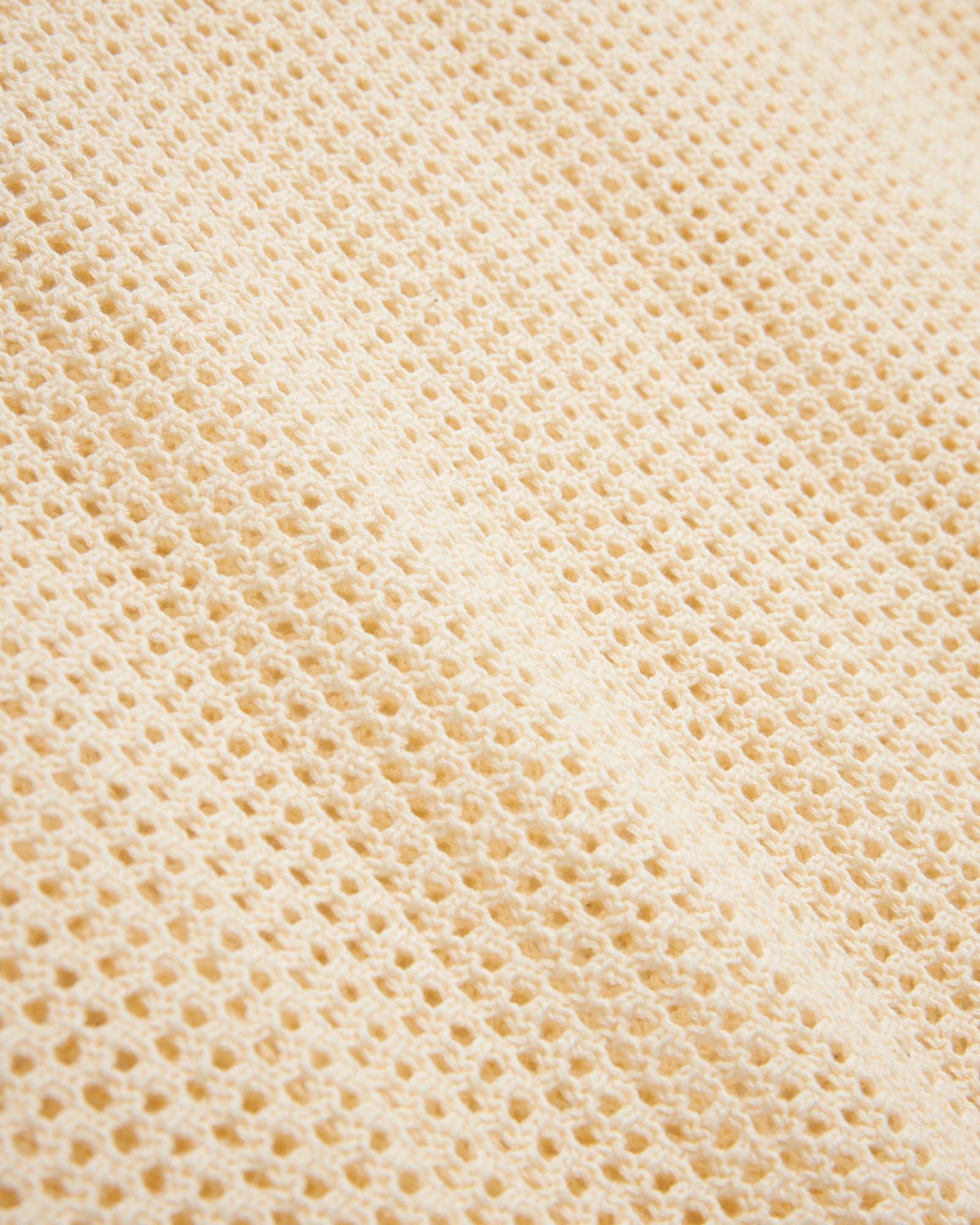 Close-up of a Vintage Ivory Dominica Crochet Tank by Dandy Del Mar with a waffle weave pattern.
