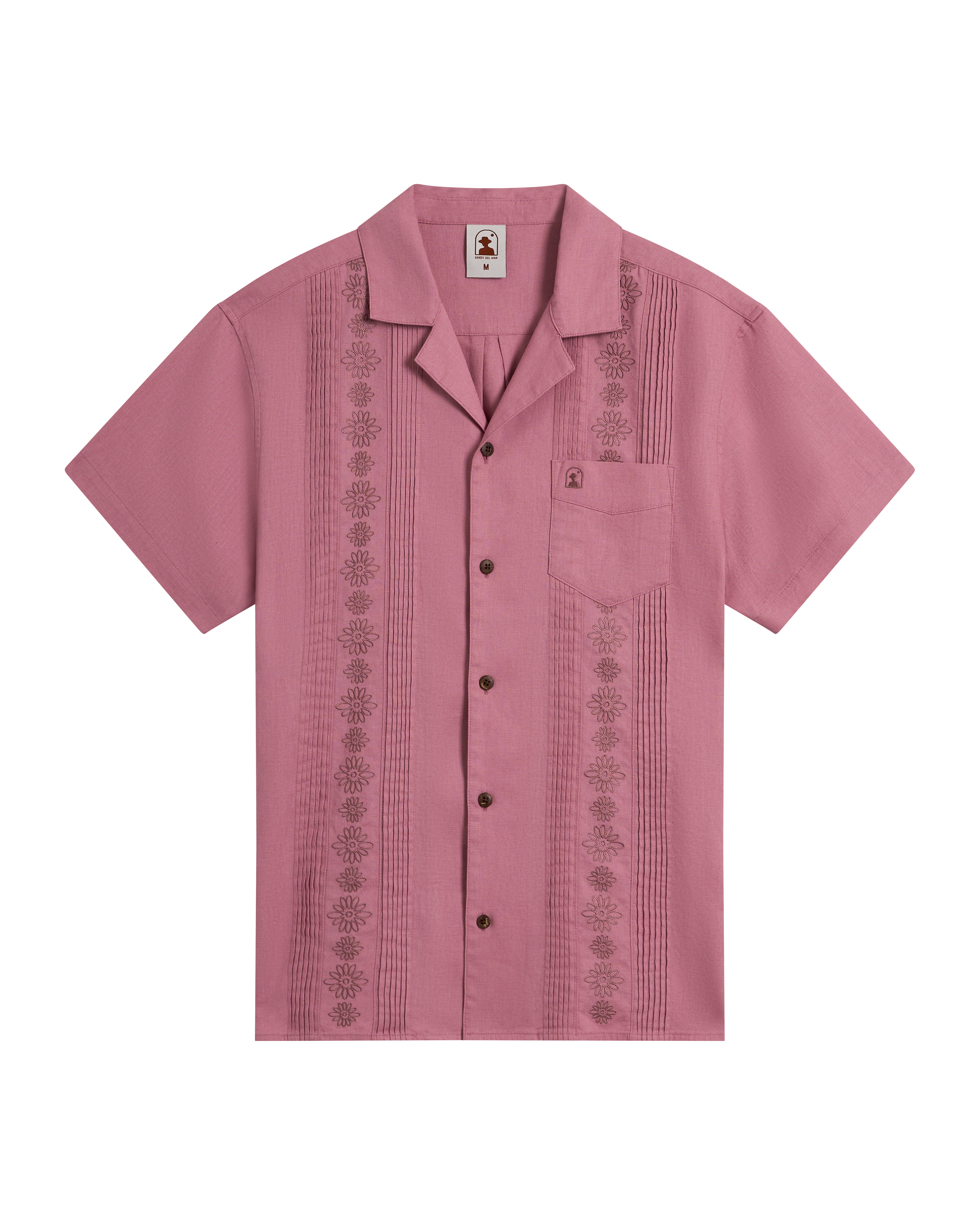 The Brisa Linen Shirt - Dawn by Dandy Del Mar features short sleeves, a button-up front, pink linen with gardenia floral embroidery, coconut shell buttons, and a chest pocket, displayed on a plain black background.