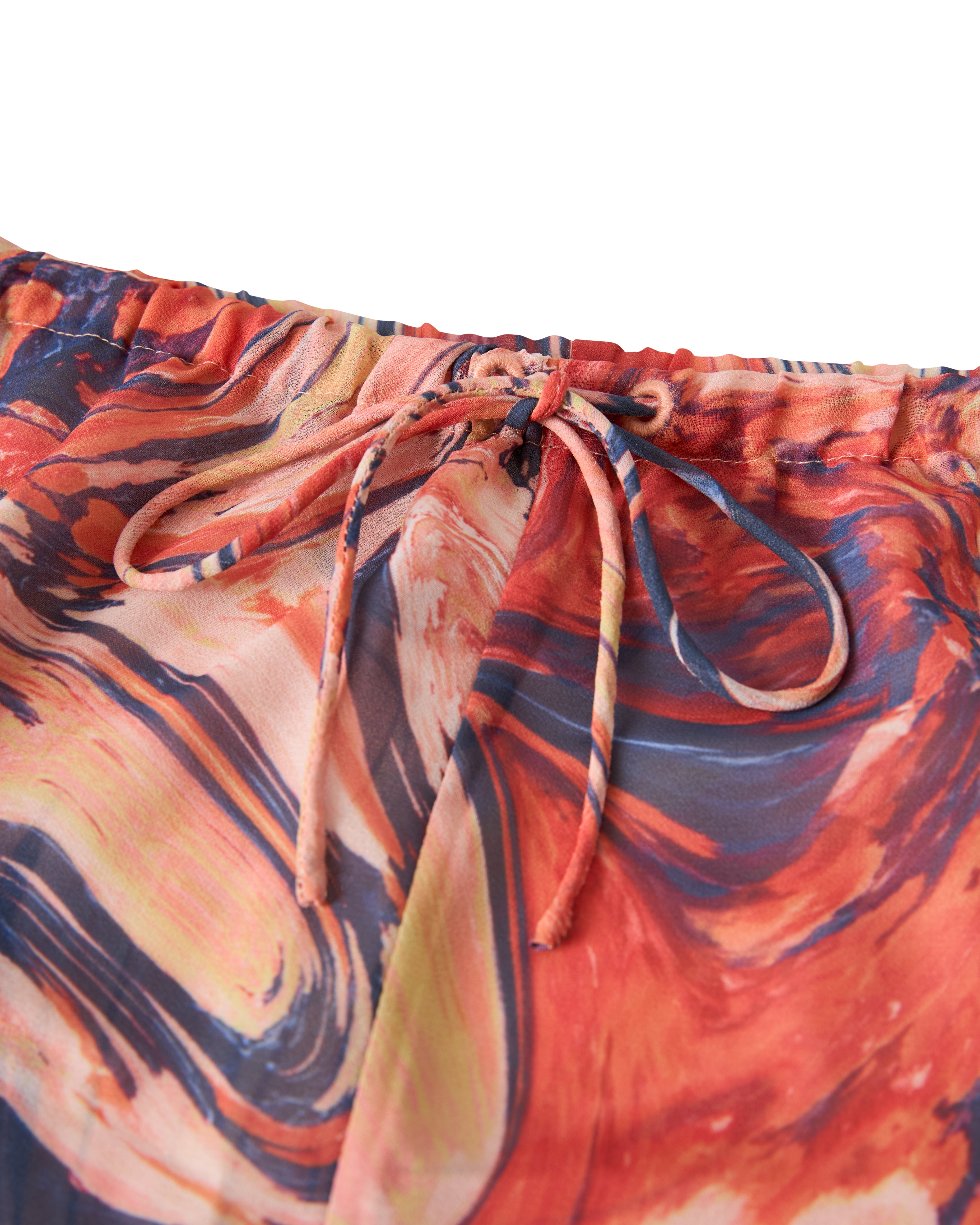 Close-up of the drawstring on Dandy Del Mar's Curacao Short - Lantana, featuring a colorful abstract swirl pattern in shades of red, orange, and blue.