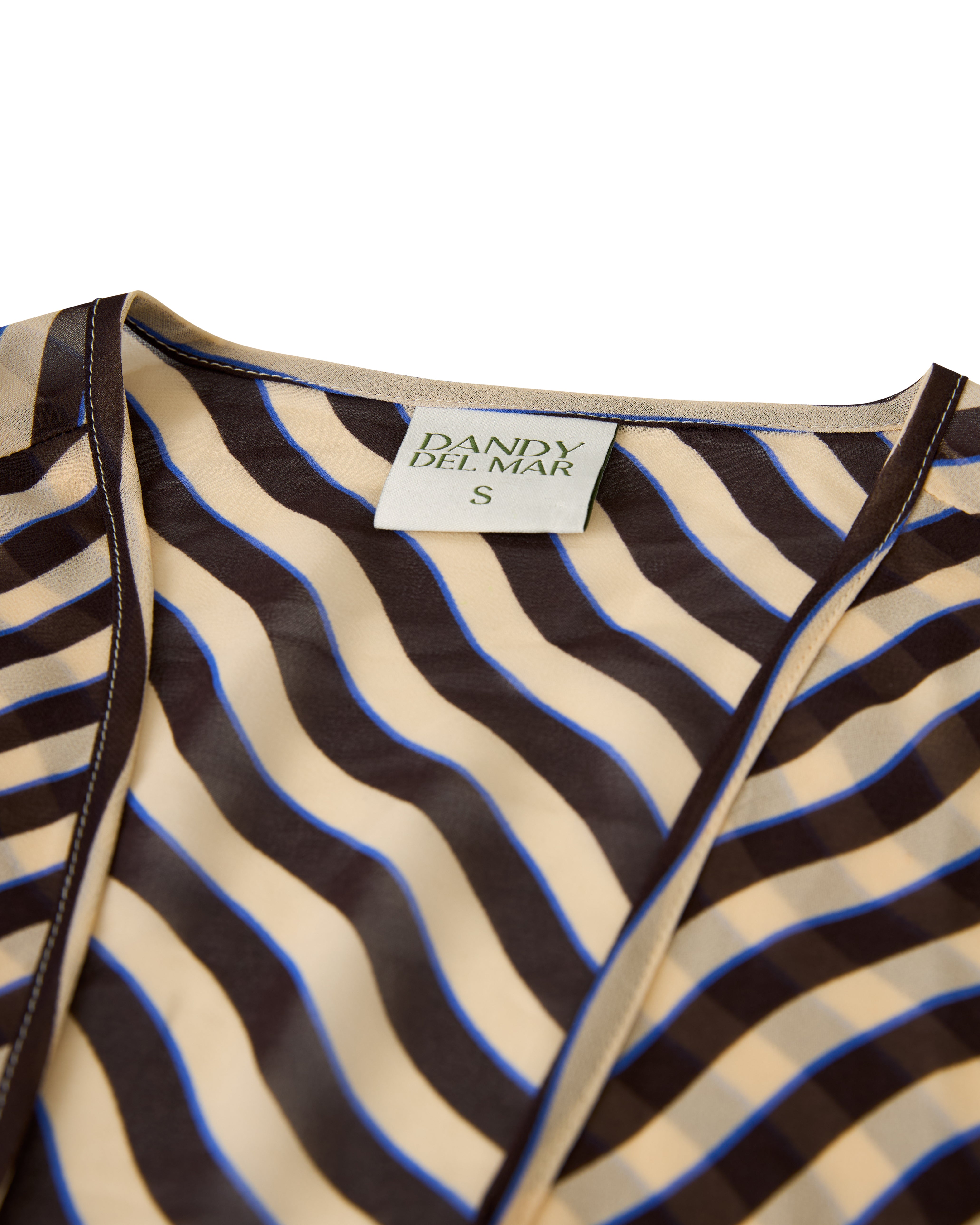 Close-up of The Curacao Top - Tierra with wavy beige and brown stripes, featuring a "Dandy Del Mar" label marked size S.