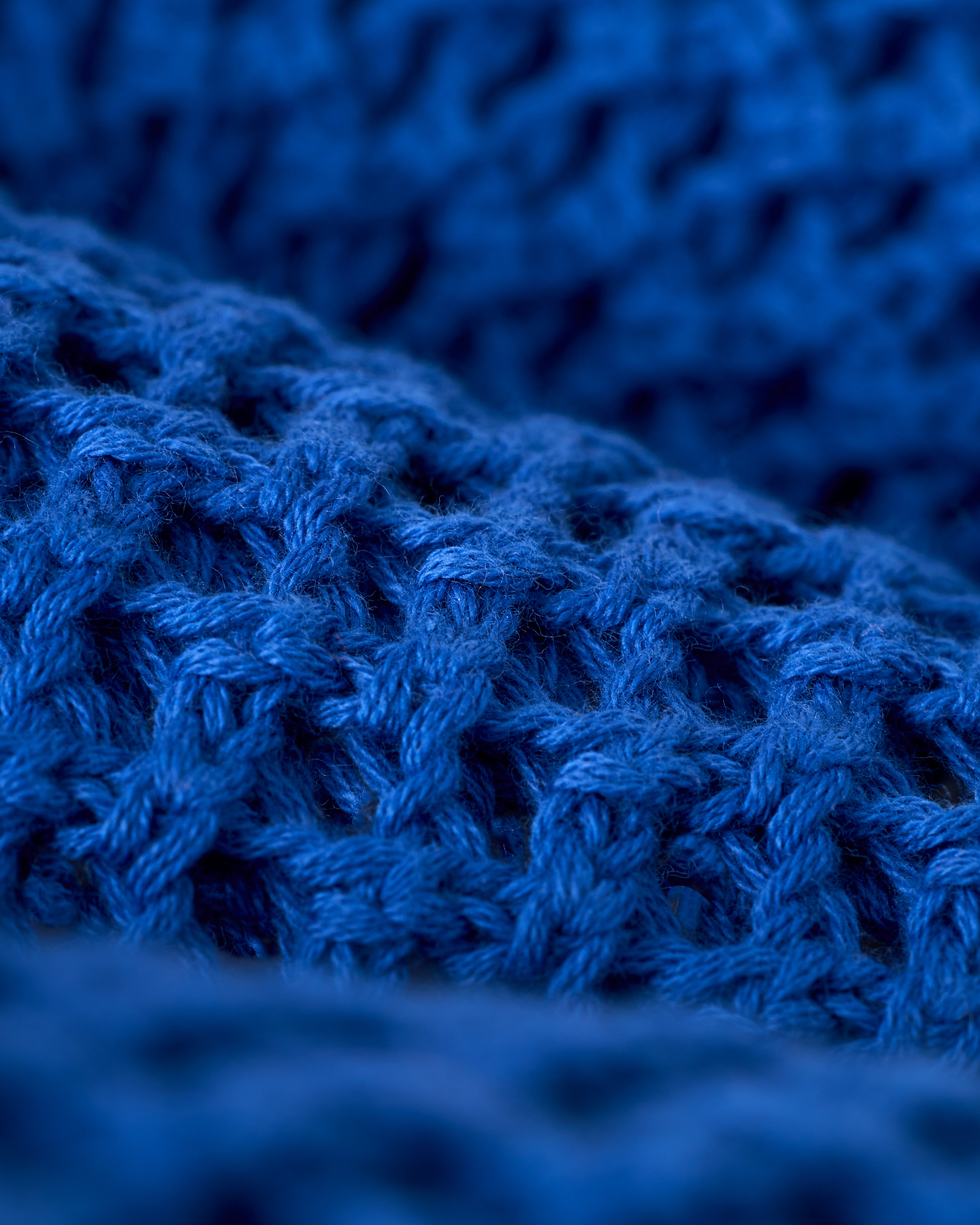 Close-up of The Malaga Crochet Skirt - Solana by Dandy Del Mar, showcasing its intricate blue yarn patterns and texture.