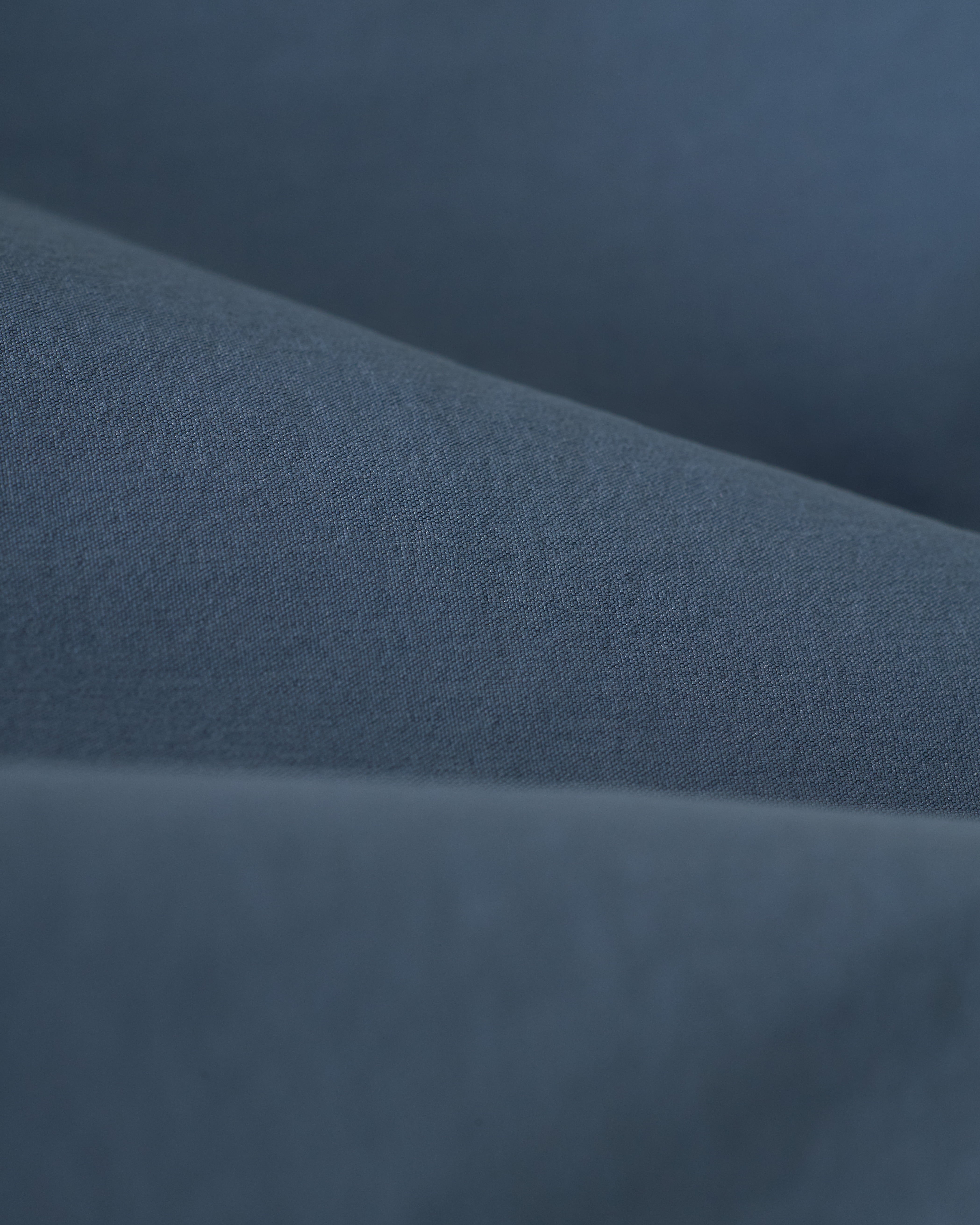 Close-up of The Stirata Swim Short - Moontide by Dandy Del Mar, featuring soft, flowing blue fabric with gentle folds and a smooth texture.