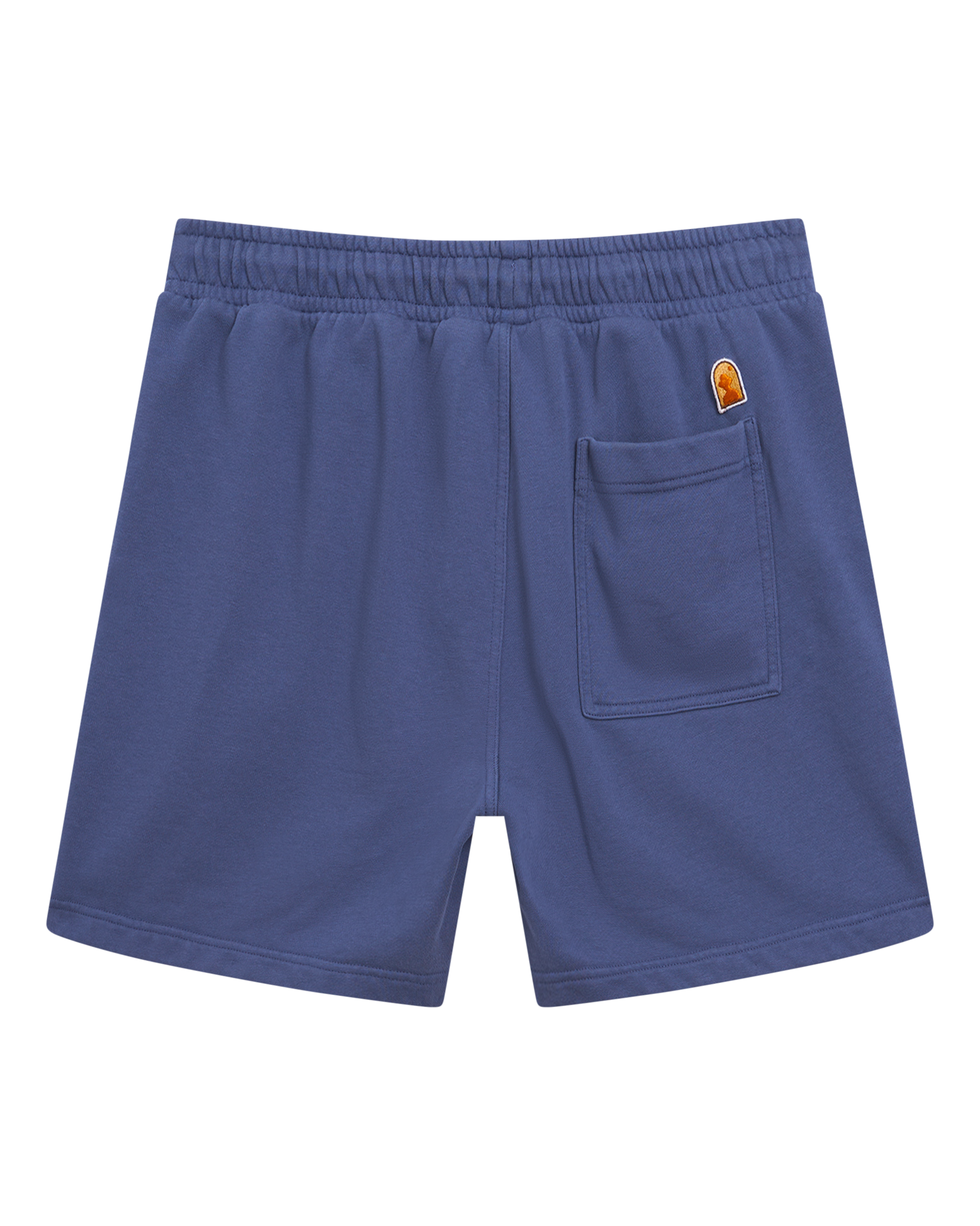 The Marseille French Terry Short - Moontide by Dandy Del Mar is a pair of blue shorts featuring an elastic waistband, a right back pocket, and a small orange patch above the pocket.