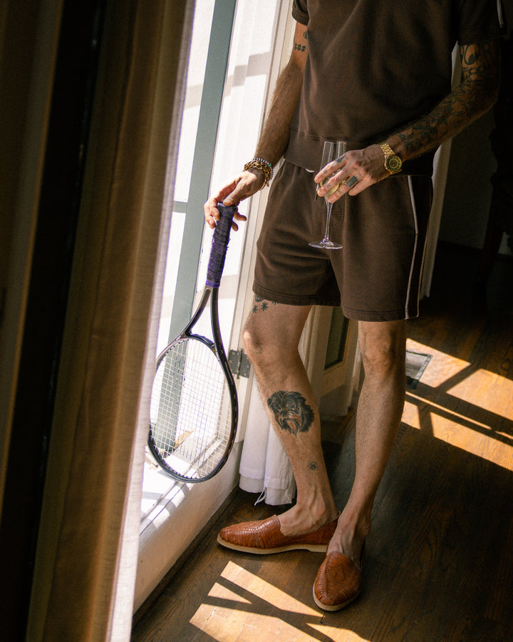 A man holding tennis racket in the the Marseille Short - Carajillo by Dandy Del Mar.