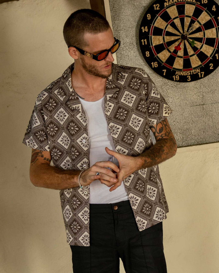 Man standing by dart board in the Carajillo Grenadine Shirt