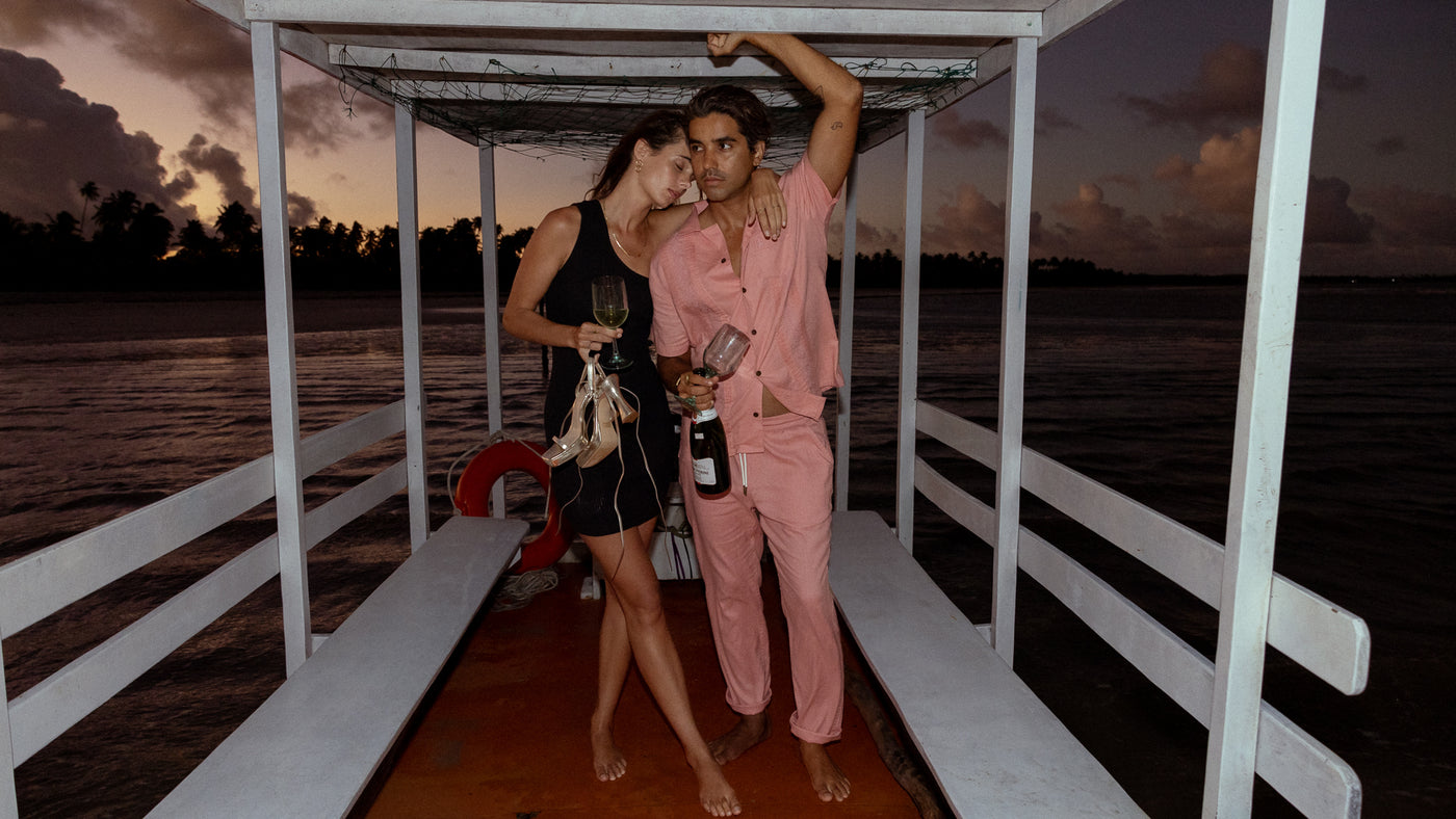 man and woman wearing dandy del mar on a boat during sunset