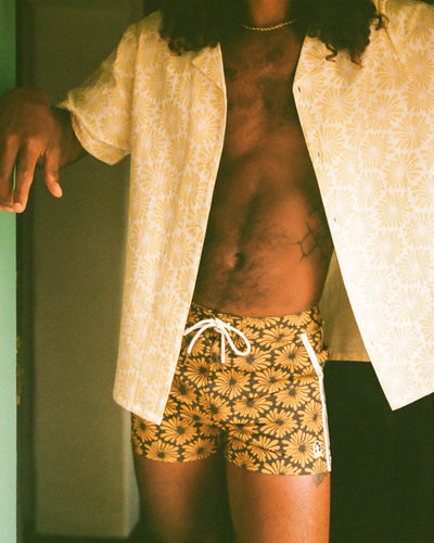 man inside in floral swim shorts and floral shirt