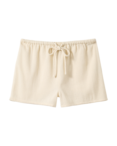 The Sevilla Shorts - Scallop by Dandy Del Mar feature a beige textured design with a comfortable elastic waistband and front drawstring. These mid rise shorts are shown flat against a white background.