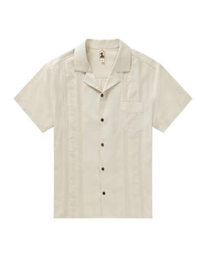 The Brisa Linen Shirt - Vintage Ivory by Dandy Del Mar features short sleeves, a chest pocket, coconut shell buttons, and vertical embroidery.