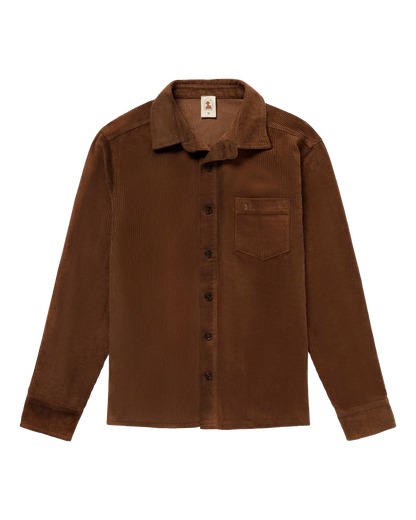 The Corsica Corduroy Shirt - Carajillo by Dandy Del Mar is a brown, Italian-made long-sleeve button-up with a front chest pocket, shown laid flat on white—ideal for versatile, elegant style.