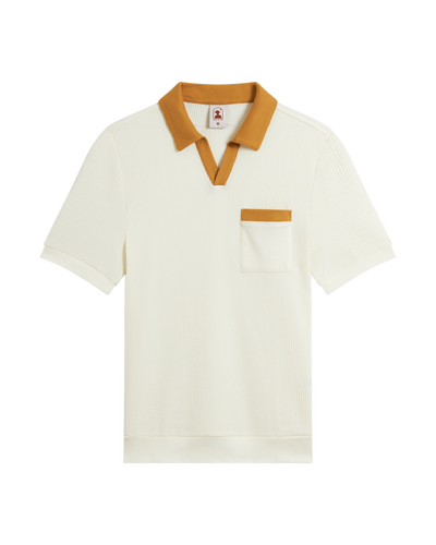The Cannes Waffle Knit Polo Shirt by Dandy Del Mar in Vintage Ivory features short sleeves and soft waffle knit fabric, accented with a mustard yellow collar, placket, and pocket trim; shown on a white background.