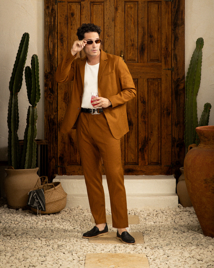 A man in a Dandy Del Mar Brisa Linen Blazer - Sedona standing in front of a cactus.