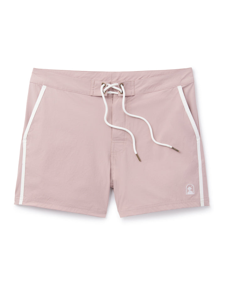 A women's Dandy Del Mar pink Stirata Swim Short - Rosado with white trim made of performance fabric for a 4-way stretch.