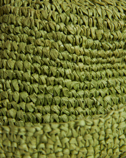 Close-up of The Amabile Raffia Hat - Verde by Dandy Del Mar, showcasing its tightly interlaced green woven texture, reminiscent of raffia-effect crochet.