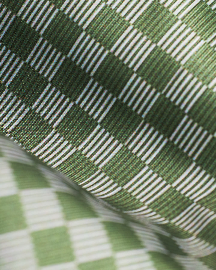 A close up of the Hierro Bottom - Berdea by Dandy Del Mar, a green and white checkered fabric.