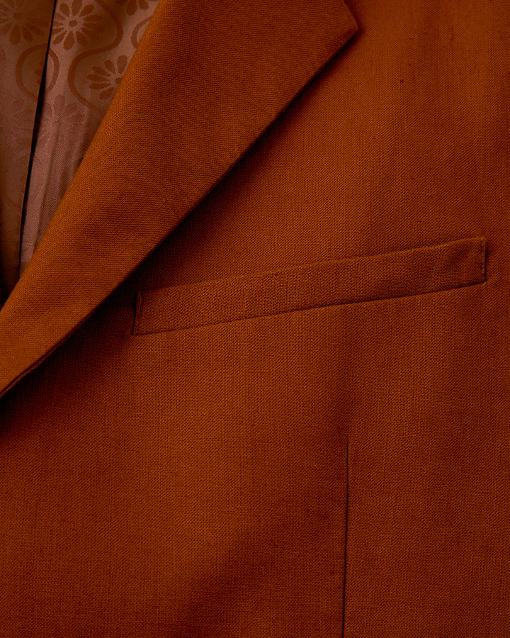 A close-up of a brown Dandy Del Mar Brisa Linen Blazer - Sedona, perfect for formal flirtations at night.