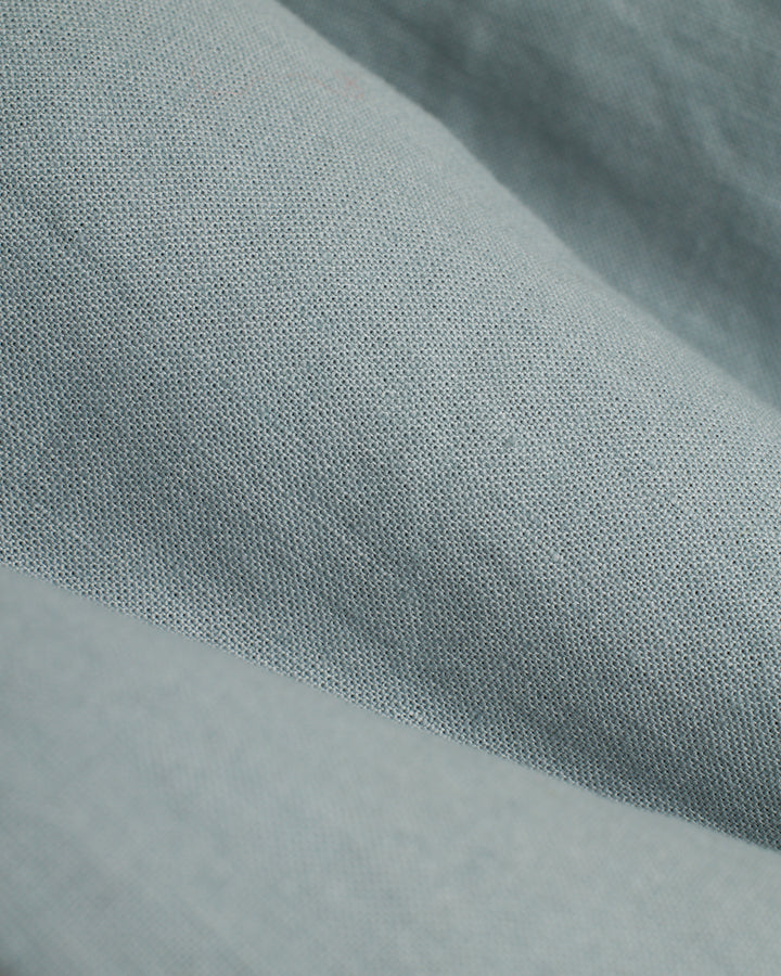 A close up of a blue Dandy Del Mar Brisa Linen Pant - Abalone, an elastic waist pant ideal for vacation.