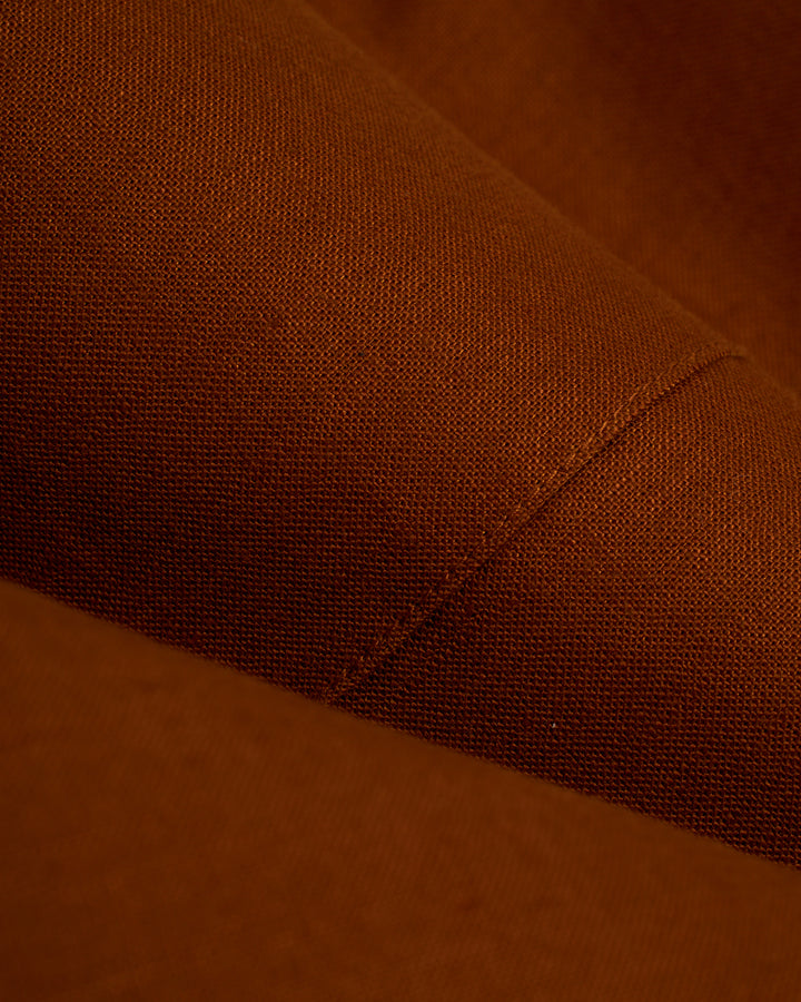 A close up of a Dandy Del Mar Brisa Linen Trouser - Sedona, a tailored fit brown fabric dress pant.