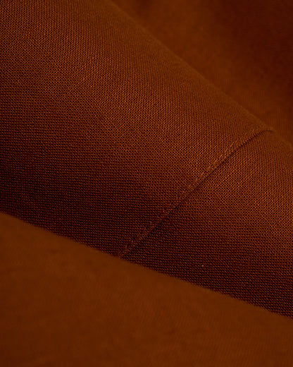 A close up of a Dandy Del Mar Brisa Linen Trouser - Sedona, a tailored fit brown fabric dress pant.