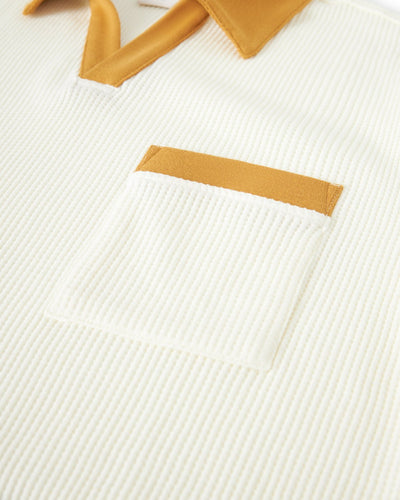 Close-up of Dandy Del Mar’s Cannes Waffle Knit Polo Shirt in Vintage Ivory—a ribbed, buttonless polo with a yellow collar and a front pocket accented by yellow trim.