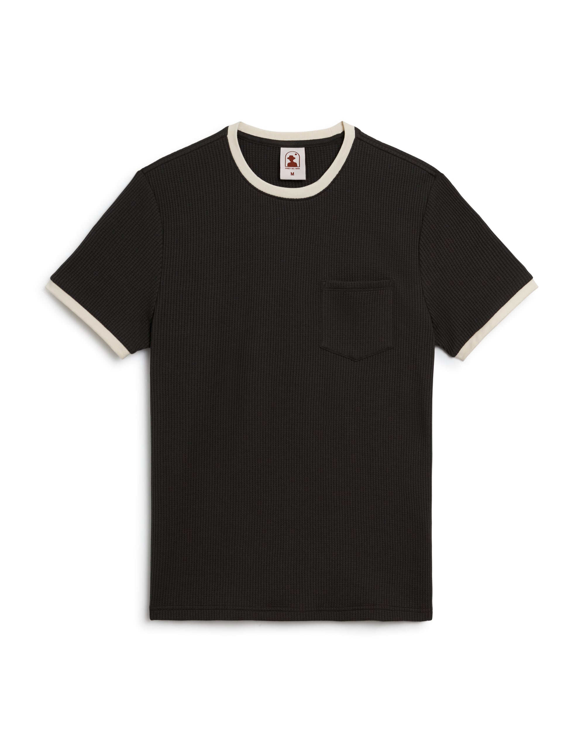 The Cannes Waffle Knit Tee - Albatross by Dandy Del Mar is a ribbed, short-sleeve black shirt with white trim on the collar and sleeves, featuring a chest pocket. Made from breathable fabric for comfort and style.