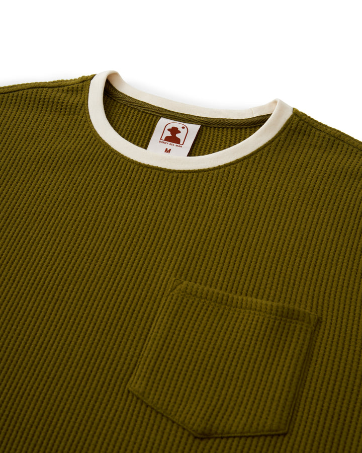 A green ribbed Cannes Tee - Arbequina t-shirt with a white pocket by Dandy Del Mar.