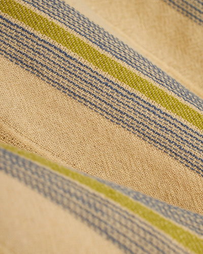 Close-up of beige fabric with blue and green stripes and a woven texture, ideal for crafting The Corralejo Shorts - Ginger by Dandy Del Mar—perfect summer essentials with a comfy elastic waist.