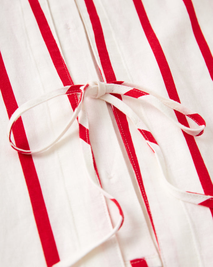 A close up of The Crete Linen Shirt - Pico by Dandy Del Mar, a red and white striped shirt.