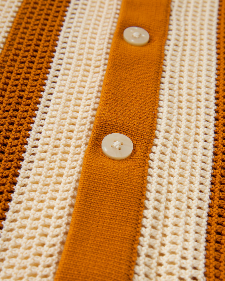 A close up of the Dandy Del Mar Dominica Crochet Shirt - Burnt Sienna Stripe in an orange and white knit pattern.