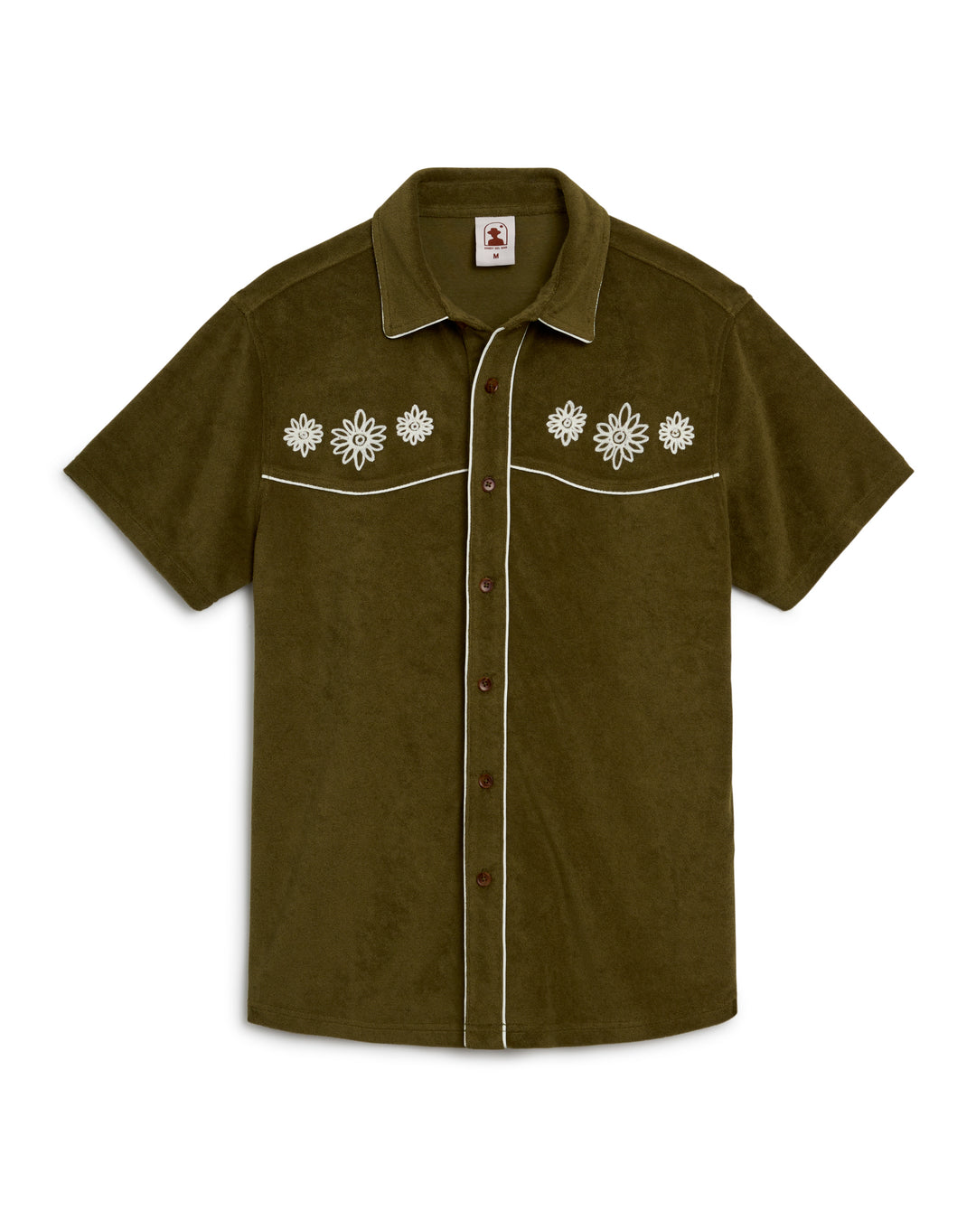A green Gaucho Shirt - Arbequina with white flowers on it from Dandy Del Mar.