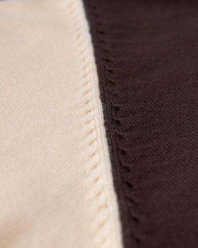 Close-up of two pieces of lightweight cotton fabric in beige and dark brown, joined by visible stitching along the seam, featured on the Dandy Del Mar Grenada Knit Baseball Tee - Tierra.