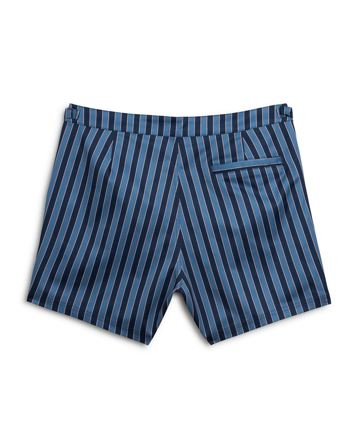 A Dandy Del Mar Mallorca Swim-Walk Short in Annapolis with adjustable antique brass side fasteners in a blue and black striped design.