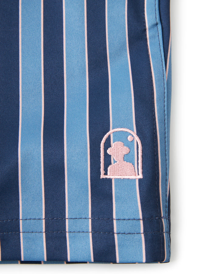 A blue and pink striped Mallorca Swim-Walk Short with a teddy bear on it, featuring adjustable antique brass side fasteners by Dandy Del Mar.