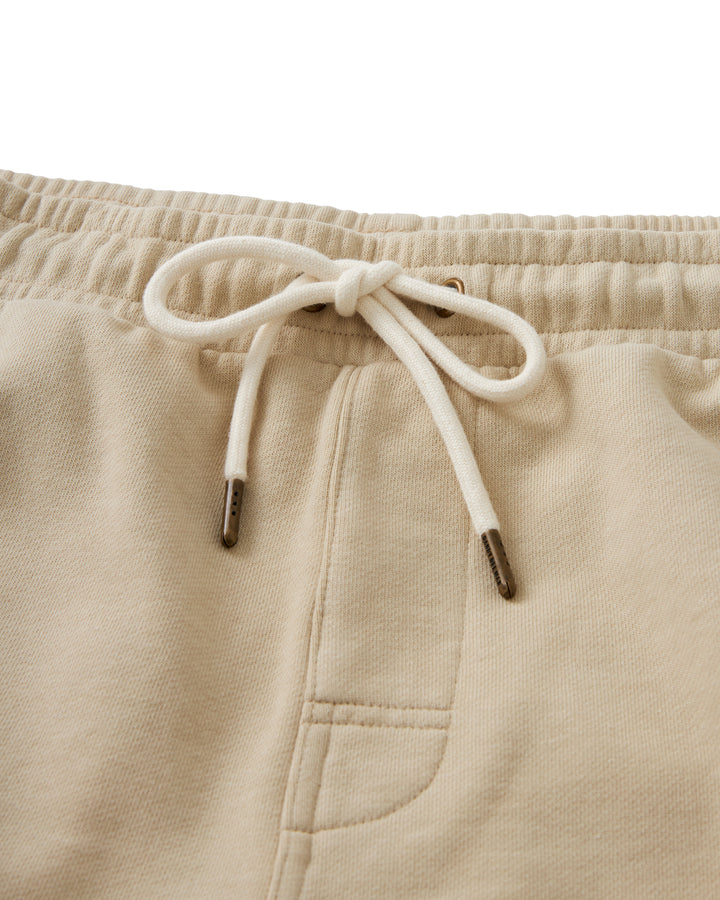 The Ginger Marseille Short is a pair of beige French terry shorts featuring a convenient drawstring for athletics activities.