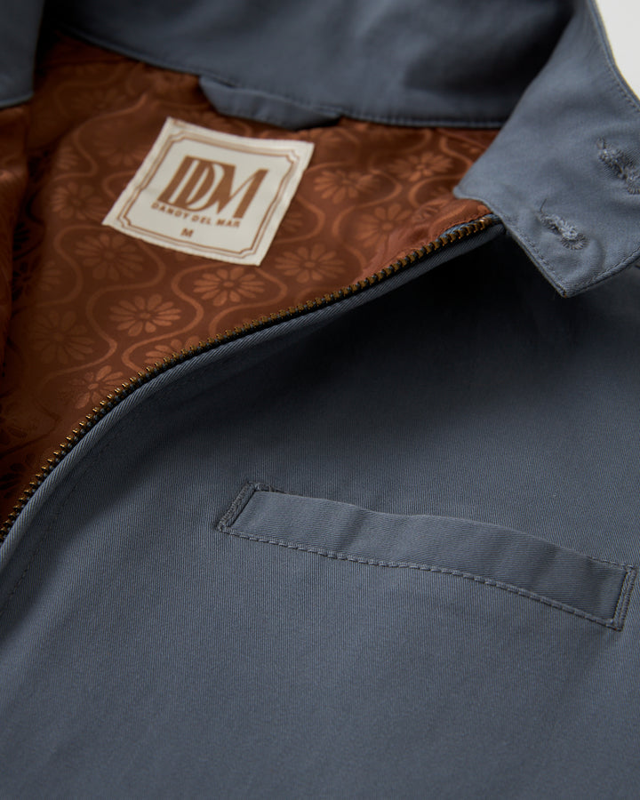 A close up of a Dandy Del Mar Rhodes Jacket - Abyss, made with lightweight shell and washed cotton twill.