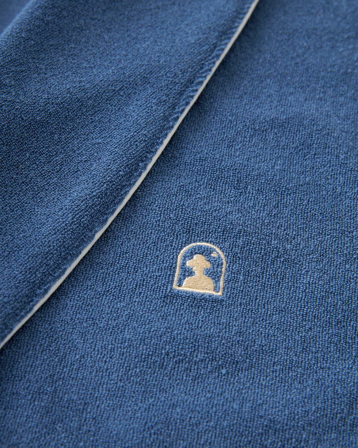 A close up of a relaxed and comfy Dandy Del Mar Tropez Robe - Annapolis with a gold logo.