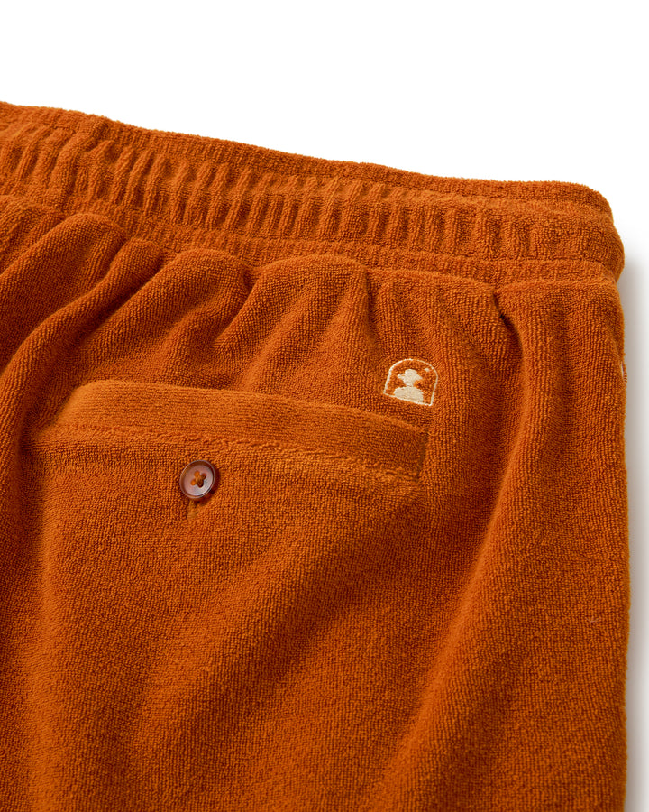 A pair of Dandy Del Mar Tropez Shorts in Burnt Sienna fleece with a pocket on the side.