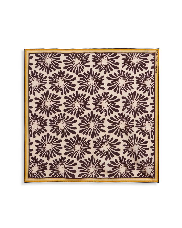 A brown and white Dandy Del Mar placemat with flowers on it, the Amalfi Woven Ascot - Carajillo Fleur.