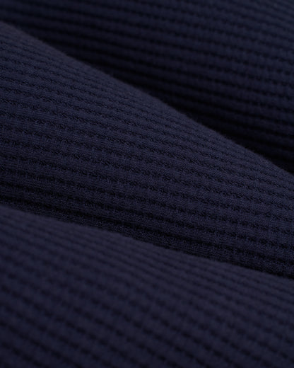 Close-up of the Luxe Navy textured fabric in The Cannes Long Sleeve Shirt by Dandy Del Mar, displaying a subtle grid pattern typical of waffle knit fabric.