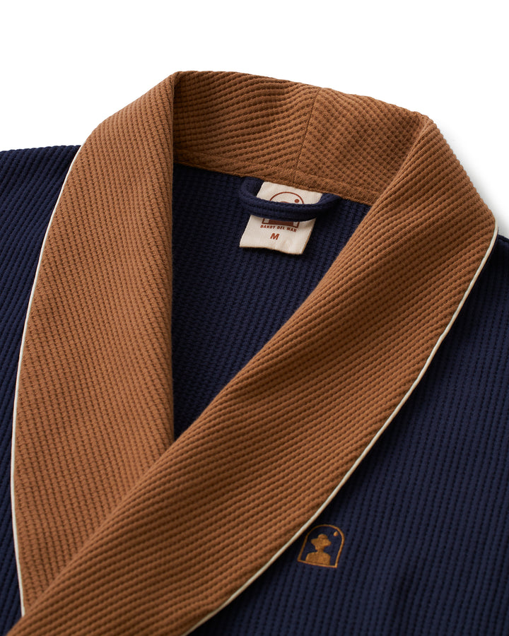 A Dandy Del Mar, Cannes Robe - Luxe Navy with a brown collar.