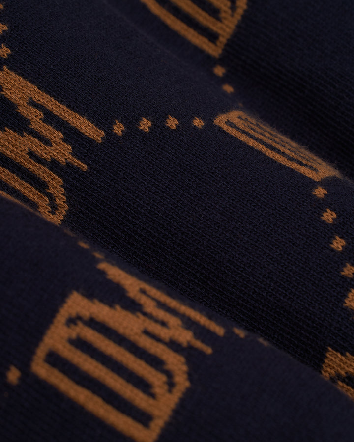 A close up of a Dandy Del Mar navy and orange striped Castello Cardigan - Abyss.