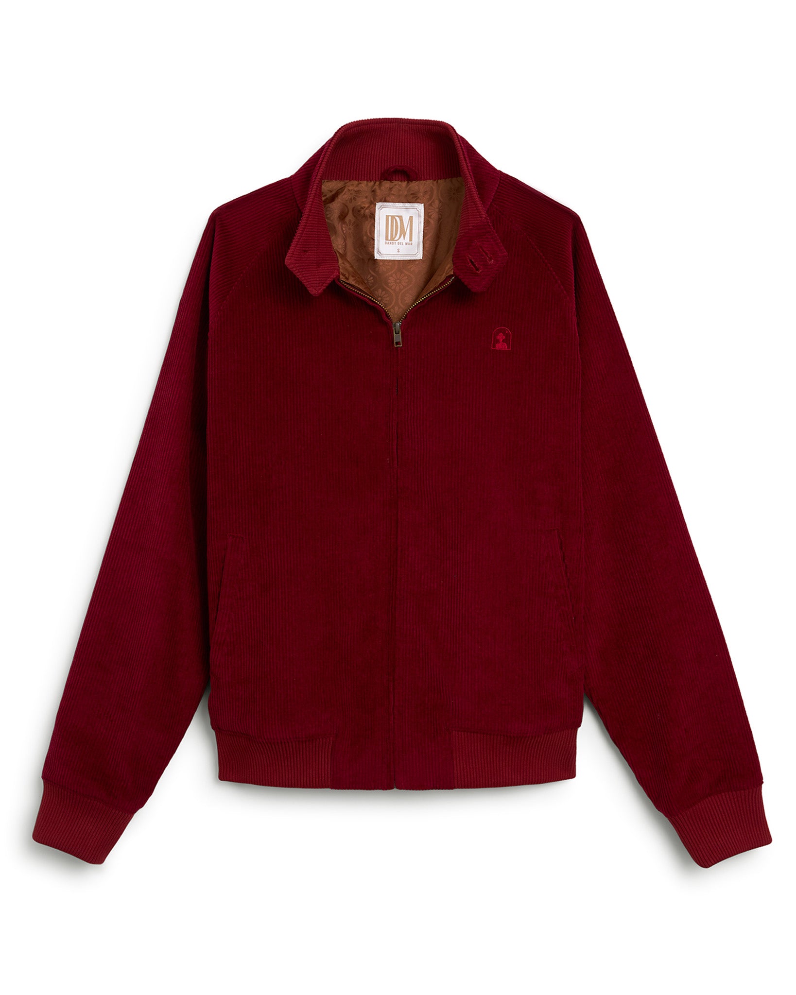 A Sangria-colored Italian corduroy Corsica Jacket from Dandy Del Mar, featuring a front zipper, two side pockets, and ribbed cuffs and hem. The interior is lined in caramel-colored material with the "DM" brand label visible inside the collar.