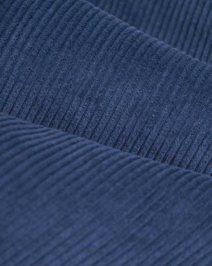 Close-up of the Moontide 8-Wale corduroy fabric from Dandy Del Mar's Corsica Corduroy Pant, showcasing its characteristic vertical ridges and textured surface with an elastic waist.