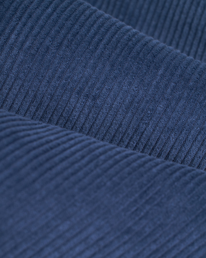 A close up image of The Corsica Shirt - Moontide in Dandy Del Mar brand, made from blue corduroy fabric.