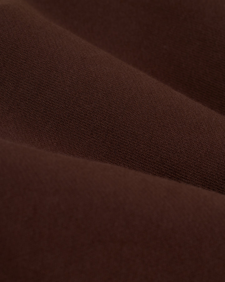 A close up of the Marseille Pullover - Carajillo by Dandy Del Mar in brown fabric.
