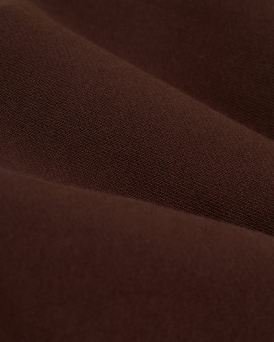 Close-up of soft, smooth brown fabric with visible weave and gentle folds, as seen in Dandy Del Mar's The Marseille French Terry Shorts - Carajillo.