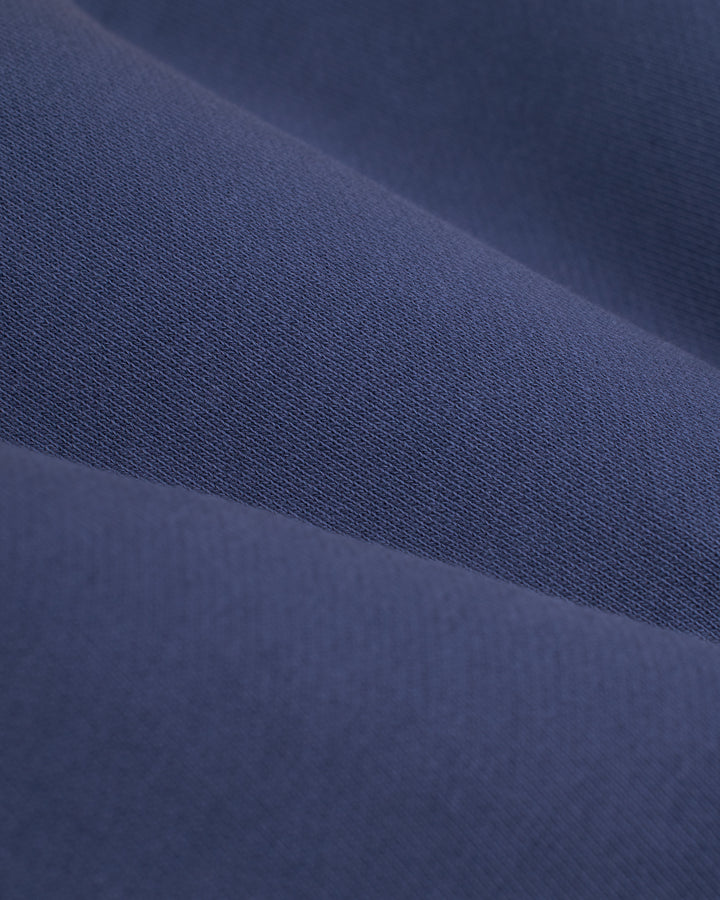 A close up image of the Marseille Pullover - Moontide by Dandy Del Mar, a dark blue fabric.